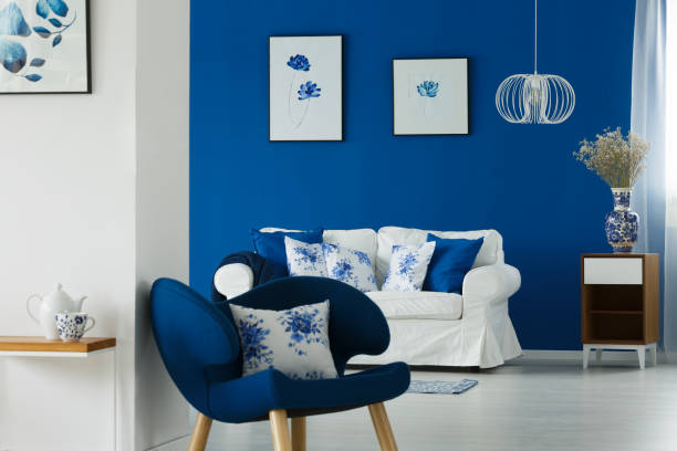 istock Sofa and chair with flowery pillows 694095054