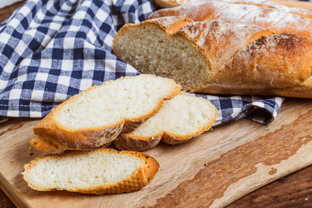 istock Assortment of baked bread on wooden table background 694099408
