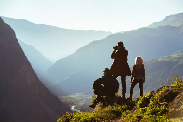Group of three friends in mountains range