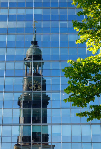 Protestant St. Michaelis Church (Sankt Michaelis Kirche, Michel) reflecting in the opposite glass facade in brilliant afternoon light.