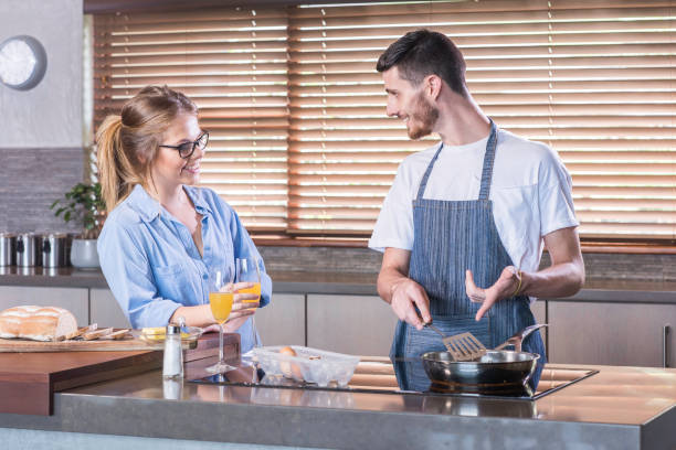istock young couple cooking breakfast kitchen happy bonding togetherness 694109184