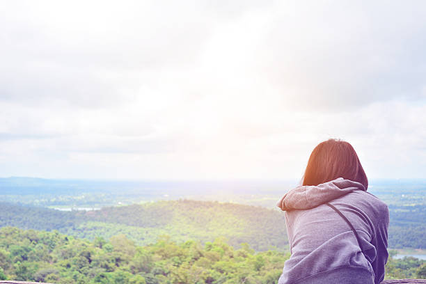 istock Woman Standing On Field Against Sky 694111211