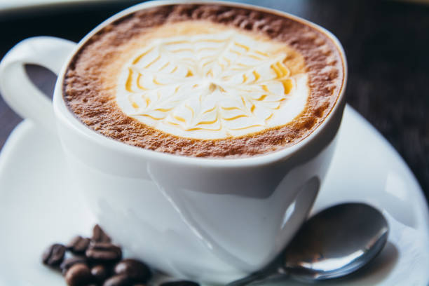 istock Coffee cup and saucer on a wooden table, shallow DOF 694113448