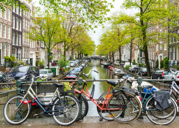 Bikes Parked on Bridge over Amsterdam Canal Bikes Parked on Bridge over Amsterdam Canal in Holland. jordaan amsterdam stock pictures, royalty-free photos & images