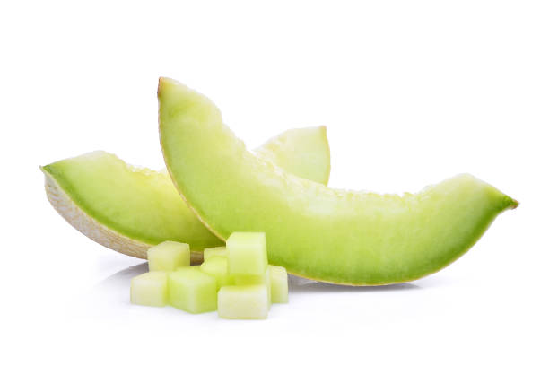 slice of green cantaloupe melon with cubes isolated on white background slice of green cantaloupe melon with cubes isolated on white background honeydew melon stock pictures, royalty-free photos & images
