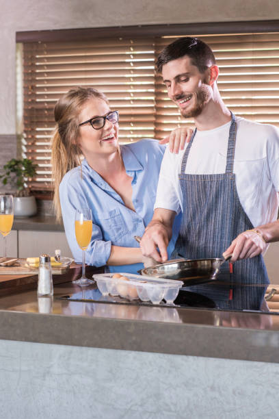 istock young couple cooking breakfast kitchen happy bonding togetherness 694120622