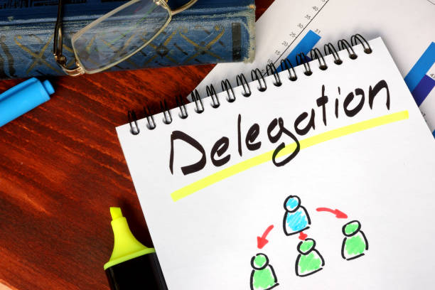 istock Notepad with Delegation on a wooden surface. 694121314