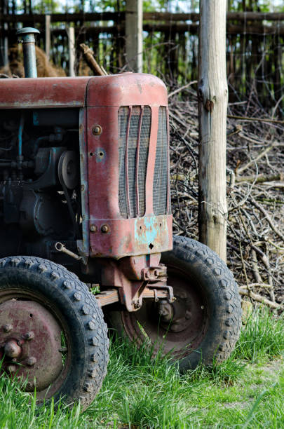 istock Old and broken tractor under improvised shelter 694121566