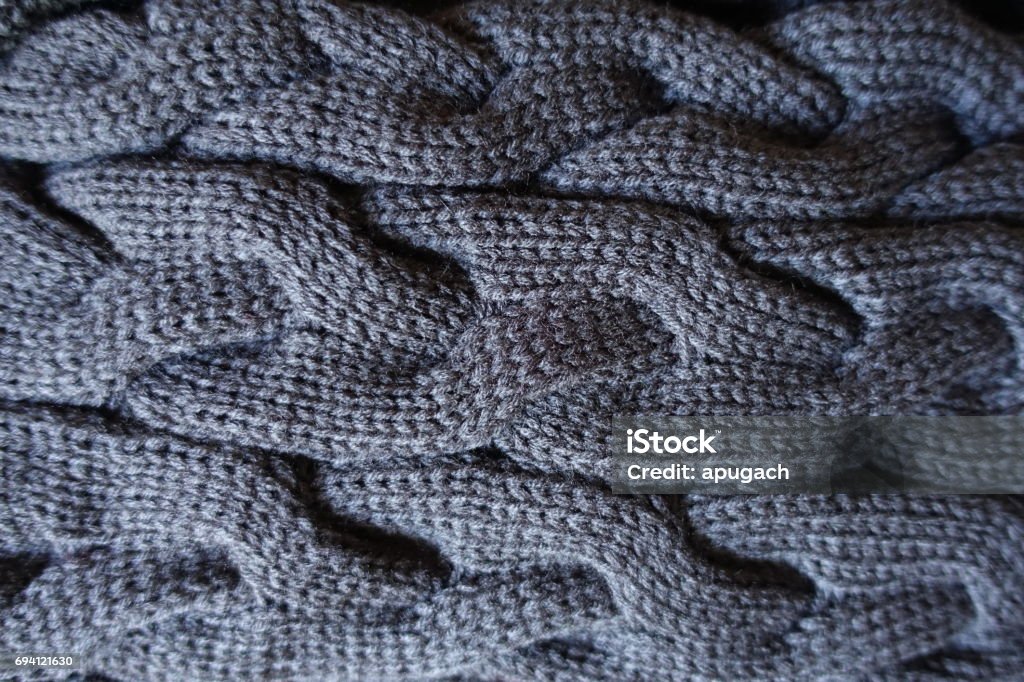 Close up of plait pattern on grey knit fabric Arts Culture and Entertainment Stock Photo