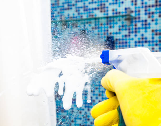 istock House chores - cleaning bathroom mirror with sprayer 694121874