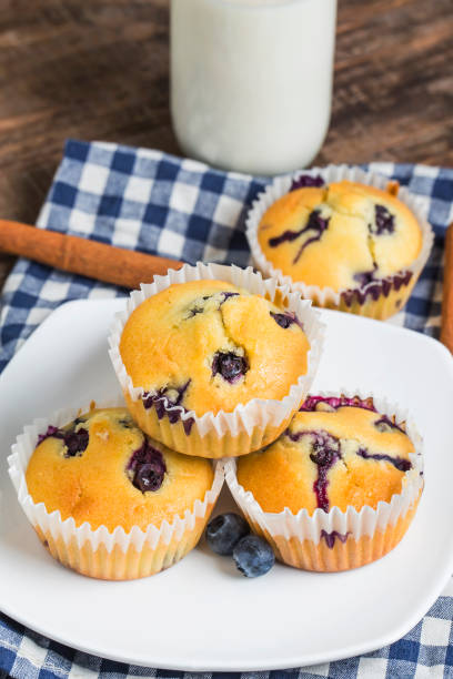 istock Blueberry muffins with powdered sugar and fresh berries 694128726