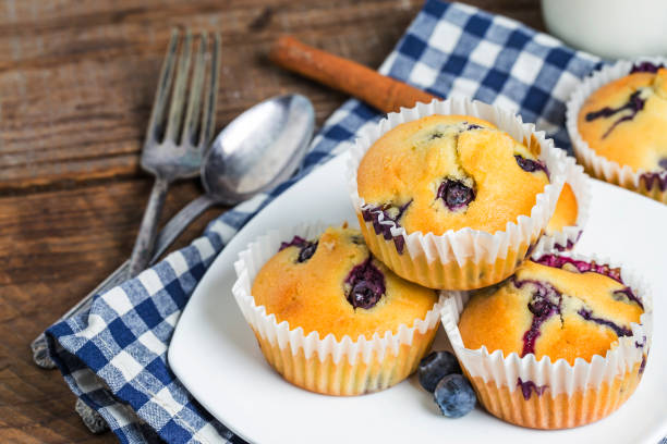 istock Blueberry muffins with powdered sugar and fresh berries 694128816