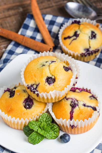 istock Blueberry muffins with powdered sugar and fresh berries 694128956