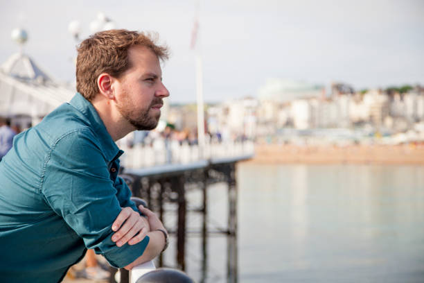 istock Handsome man leaning on a railing in a touristic city 694137718