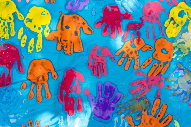 istock Colorful children hand prints on blue 694150524