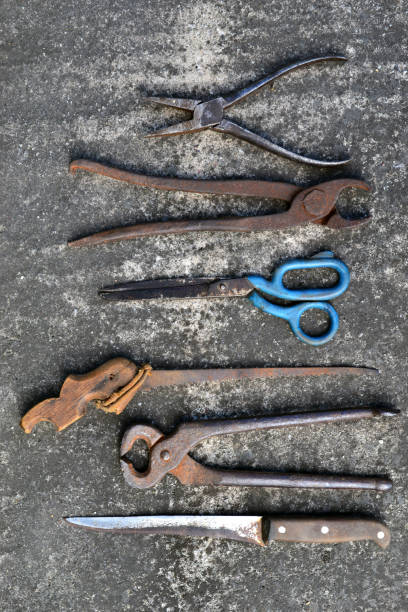 Old rusty tools lie on concrete stock photo