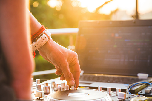 Dj mixing music outdoor. DJ's hands mix the sound on the control panel