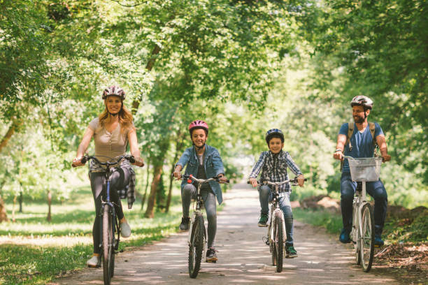 istock Family riding bicycle together 694171296