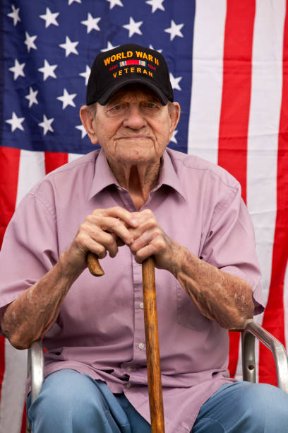 istock World War Two, Veteran wearing  baseball cap with text, 