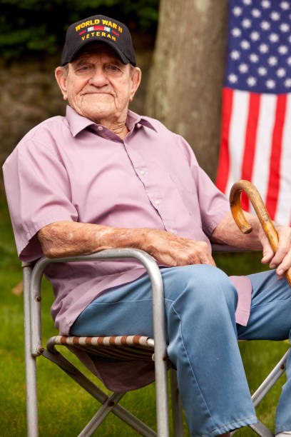 istock World War Two, Veteran wearing  baseball cap with text, 