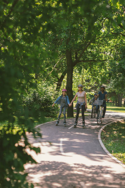 istock Family roller skating and riding bicycle 694172040
