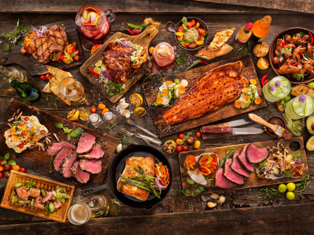 bbq Feast With: Salmon, Steaks, Beef Roast,pork tenderloin,pork chops, Halibut, Chicken wings, grilled fruit, breads and Drinks seafood photos stock pictures, royalty-free photos & images
