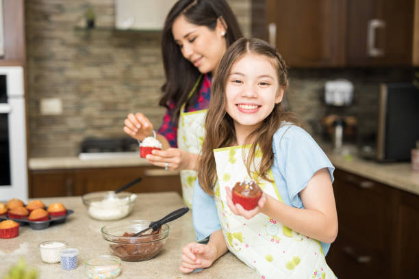 istock Happy girl baking with her mom 694177884