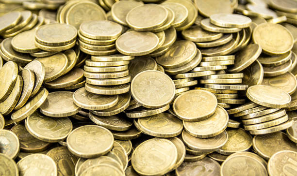 istock A lot of coins on a white background 694177918