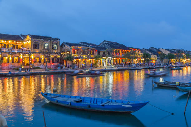 Hoi An Ancient Town at Night A view over the  Thu Bon River towards Bach Dang street in Ancient Town. Colourful lights, buildings, reflections and people can be seen. thu bon river stock pictures, royalty-free photos & images