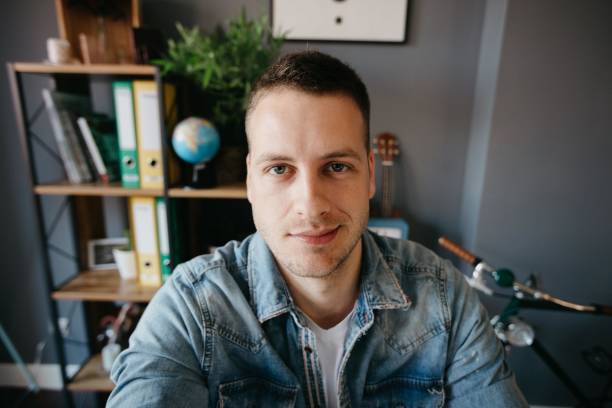 istock Cute man with a smirk on his face taking a selfie 694185084