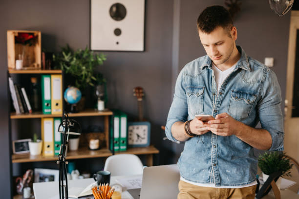 istock Gorgeous guy is checking a social media on the smartphone 694185146
