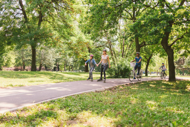istock Family roller skating and riding bicycle 694185166