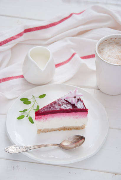 istock Berry cheesecake on a white wooden background 694189054