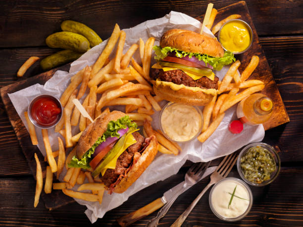 Burgers and Fries Classic Cheeseburger, Bacon Cheeseburger, French Fries and Beers burger stock pictures, royalty-free photos & images
