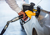 Man hand holding yellow petrol pump