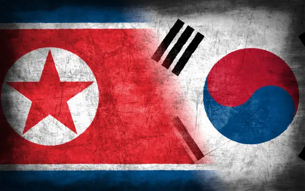 Photo of North Korea and South Korea flag with grunge metal texture