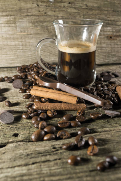 istock Cinnamon, Cup and grain of coffee 694205572