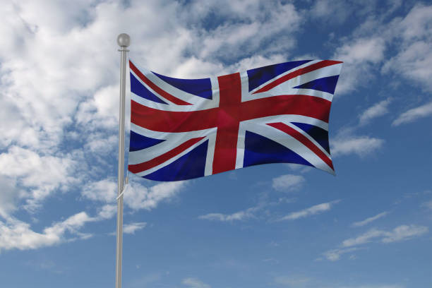 istock Great Britain flag waving in the sky 694208020