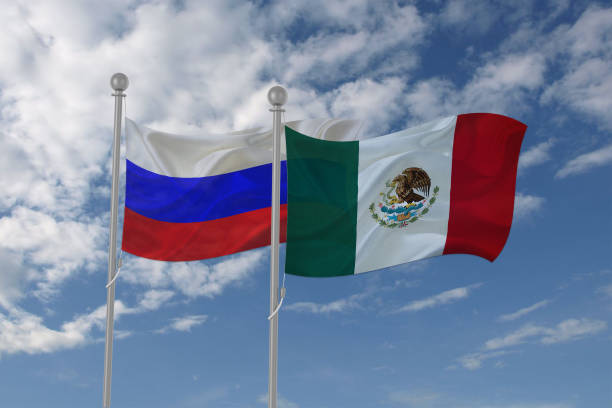 istock Russia and Mexico flag waving in the sky 694208052