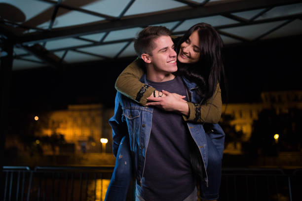 istock Young man piggyback her girlfriend 694208266
