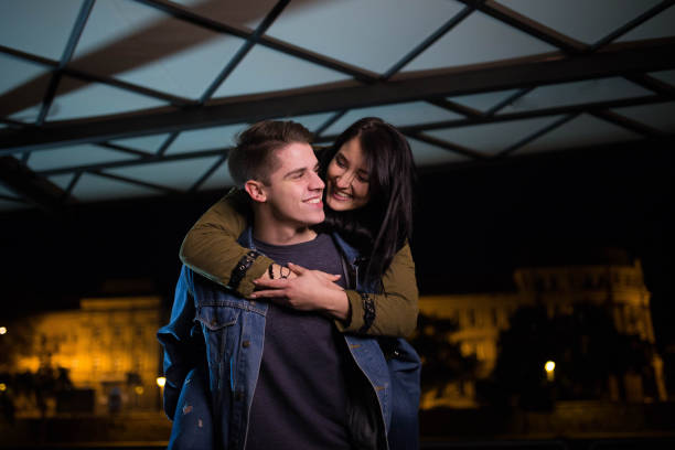 istock Young man giving his girlfriend piggyback ride 694208268