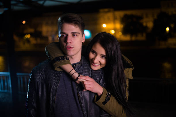 istock Young man piggyback her girlfriend 694208472