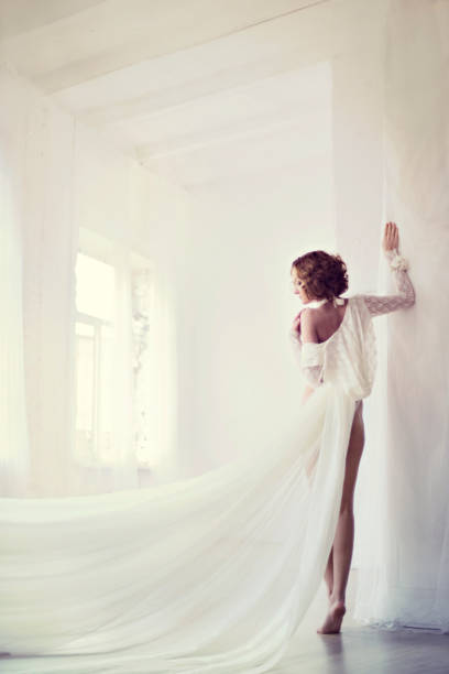 istock Beautiful sexy lady in elegant white bodysuit 694208532