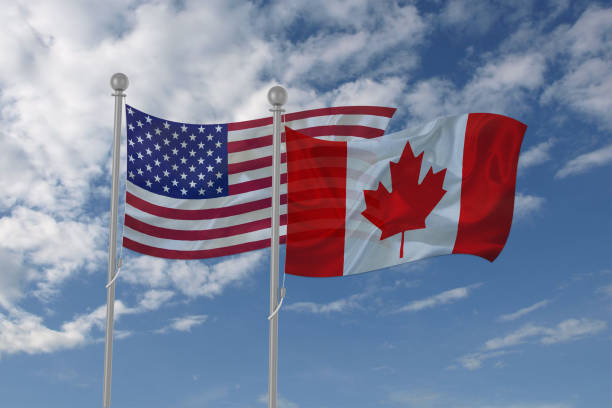 istock USA and Canada flag waving in the sky 694209126