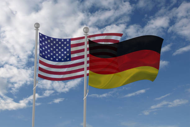 istock USA and Germany flag waving in the sky 694209168