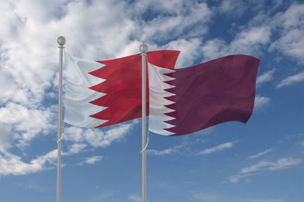 istock Bahrain and Qatar flag waving in the sky 694209276