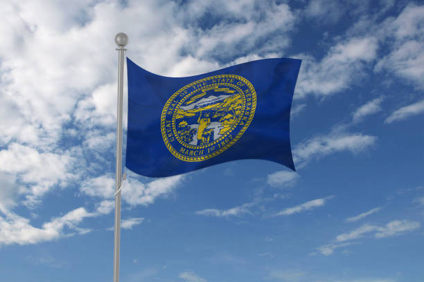istock Nebraska flag waving in the sky 694212504