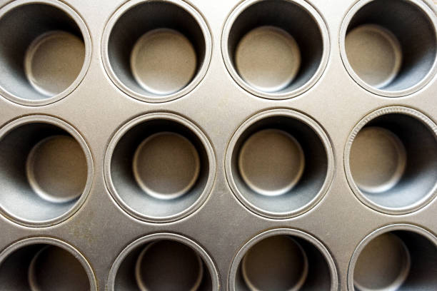 Empty Cup Cake Baking Tin Empty Cup Cake cooking and baking tin from overhead metal molding stock pictures, royalty-free photos & images