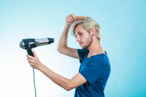 istock Trendy man with hair dryer 694220580