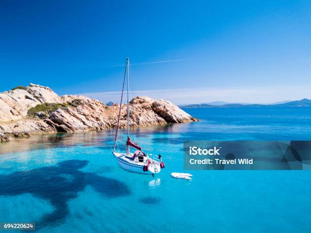 Aerial View Of A Sail Boat In Front Of Mortorio Island In Sardinia Amazing Beach With A Turquoise And Transparent Sea Emerald Coast Sardinia Italytn Stock Photo - Download Image Now